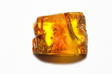 Amber with inclusions on a white background. Patterns in the mineral. Decorations. Sun stone. Jewelry material. Ancient fossilized resin. Copal. Transparent crystal. Geology. colored resin 