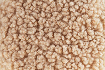 Beige wool background natural sheepskin close-up