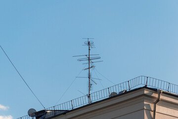 Television antenna on the roof of the house, against the blue sky