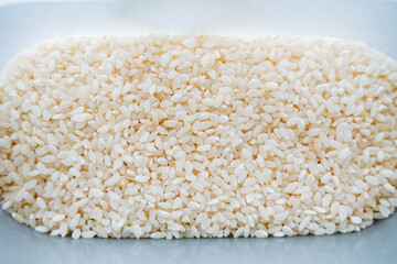 rice groats top view. White rice is shot close-up. The grains are in heaps.
