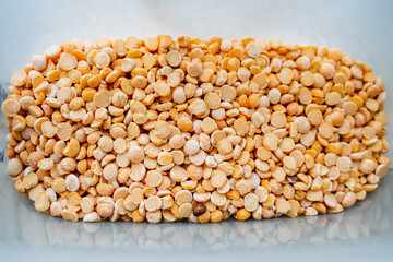 Ripe peas are dry. Grains of traditional peas. Cereal yellow, orange color. Top view of raw food.