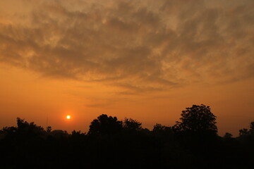 Orange light of Sunrise ,silhouette and clouds sky in the early morning