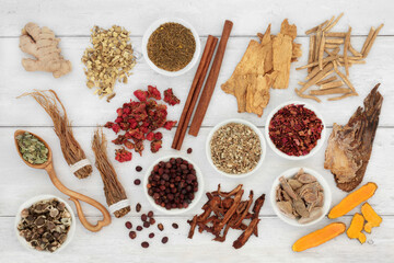 Herbal plant medicine herb and spice collection to boost the immune system on rustic wood background. Healthy food high in antioxidants, anthocyanins, vitamins and minerals.