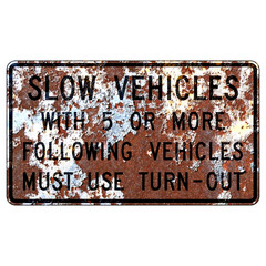 Old rusty American road sign - Slow vehicles with 5 or more following vehicles must use turn-out