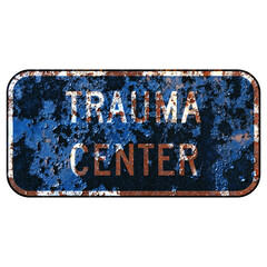 Old rusty American road sign - Trauma center