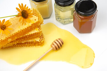 Fresh flower honey in a wooden bowl, spoon, pollen and honeycomb. vitamin food for health and life