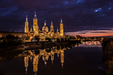 Fototapeta na wymiar Cathedral-Basilica of Our Lady of the Pillar with evening lights, Roman Catholic church in the city of Zaragoza, Aragon 