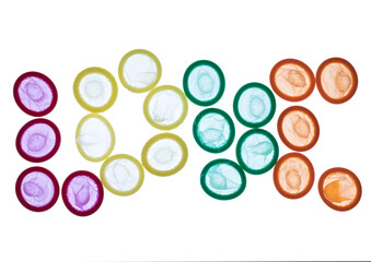 Set of colorful unrolled condoms on isolated background arranged on the letters formation of the word "LOVE " 