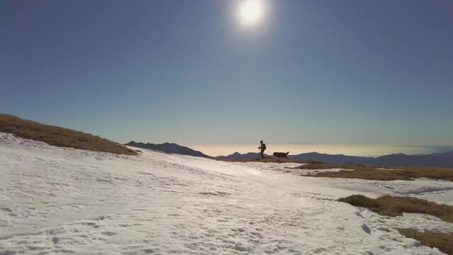 Girl with her inseparable dog in the high mountains