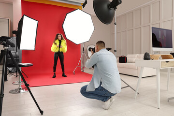 Beautiful African American model posing for professional photographer in studio