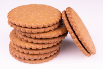 Chocolate chip cookies with filling on white background.	