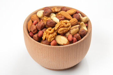 Different nuts in a wooden bowl on a white background. Vitamin wholesome food.