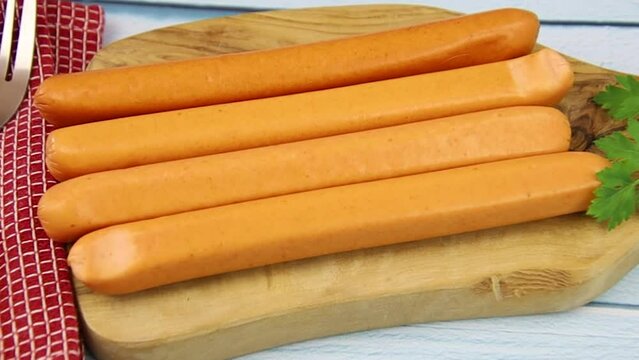 several raw sausages on a wooden board