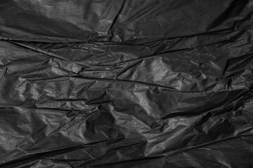 Texture of black crumpled paper.