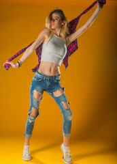Young Woman In Yellow Tanktop And Eye Glasses Against Yellow Background