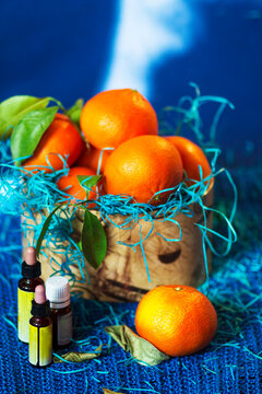 Tangerines In A Gift Box And Bottles Of Essential Oils