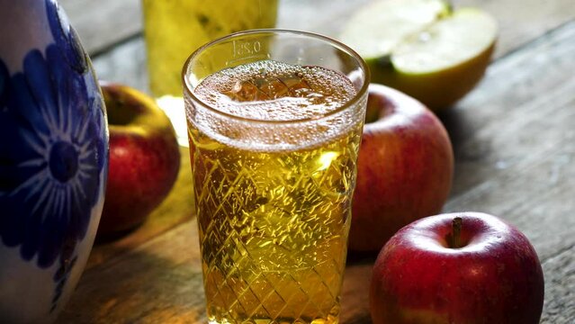Pouring a glass of Apfelwein, Bembel and apples - traditional hessian drink, Apfelwein - apple wine - is a very strong kind of cider drink which is typical for the Rhein-Main-Area in Germany