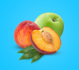 Ripe peach fruit one cut in half with bone and green leaf and green apple