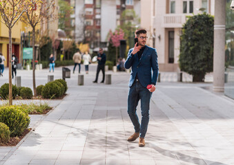 Fashionable businessman using mobile outdoors
