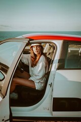 Naklejka premium woman in a car on the beach in lagos algarve portugal 