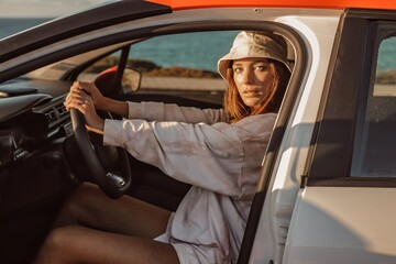 woman in a car on the beach in lagos algarve portugal 