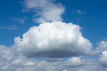 Blurred image of a cloud against a blue sky.