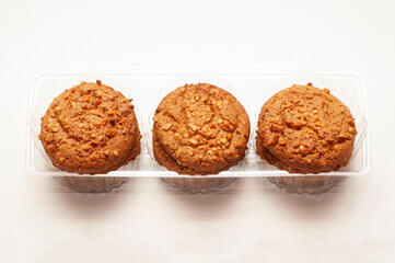 Delicious and healthy snack. Photo of oatmeal cookies with peanut crumbs in a plastic container.