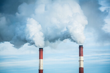 Closeup view steam coming out of pipes of thermoelectric power station in winter time.