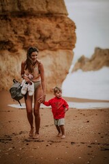 woman with her child on the beach in lagos algarve portugal 
