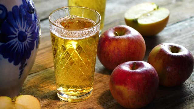 Pouring a glass of Apfelwein, Bembel and apples - traditional hessian drink, Apfelwein - apple wine - is a very strong kind of cider drink which is typical for the Rhein-Main-Area in Germany
