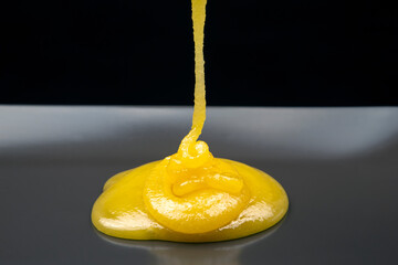 Fresh flower honey flows down from the plate. vitamin organic food