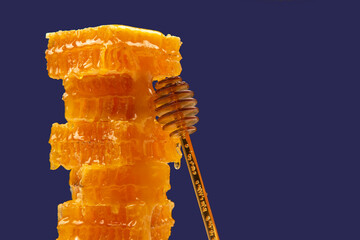 pyramid of fresh honeycomb with a spoon. vitamin organic food