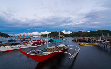 Fototapeta na wymiar Fishing boats on a calm sea in an early summer day