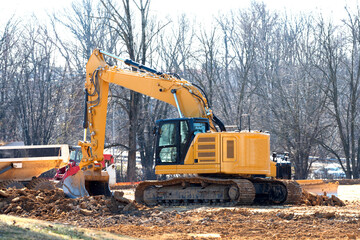 Excavator on a working platform yellow shovel