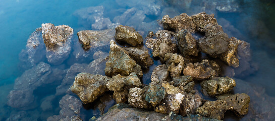 Rocks on a blue colored seawater