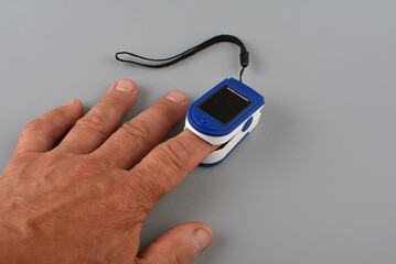 Pulse oximeter on a female hand.