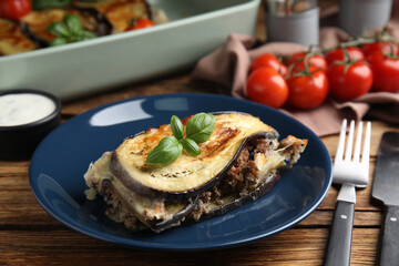 Delicious eggplant lasagna served on wooden table