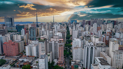 Obraz premium Aerial view of Av. Paulista in São Paulo, SP. Main avenue of the capital. With many radio antennas, commercial and residential buildings. Aerial view of the great city of São Paulo. Sunset