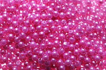 Pile of pink beads as background, closeup