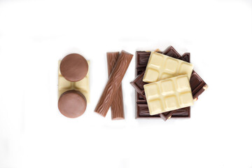 Composition of different types of chocolate at white background