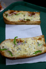 baked toasty cooked with bread onion and jalapeno with cheese on top