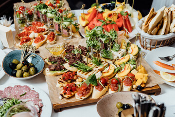 A set of juicy servings of steak, cheese platter, healthy vegetable platter, meat, sandwiches, fruits, carpaccio and tartare. Healthy food