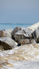 Ice and snow covered rocks along the shoreline of Lake Michigan at Gillson Beach in Wilmette, Illinois.  