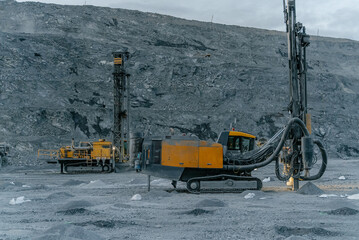 Drilling rig in an open pit in the evening.