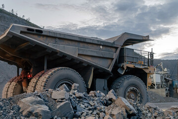 A dump truck drives through a gold mine site.