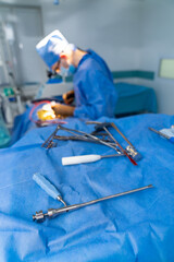 Surgeon in special surgery glasses provides operation. Tools at the first plan. Careful attentive...