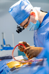 Neurosurgeon is operating with medical robotic surgery machine. Manual control by Minimally...
