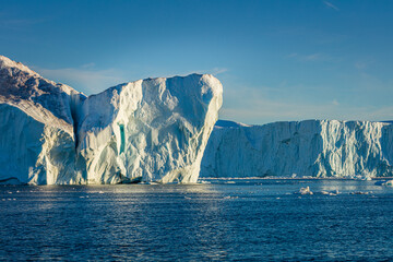 Fototapeta na wymiar Wall of ice in the sea at the mouth of the Ilulissat icefjord, Greenland 