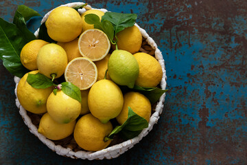 Fresh lemons with leaves in a basket