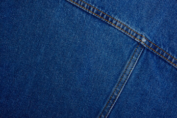 blue denim fabric with seams closeup - horizontal textile background